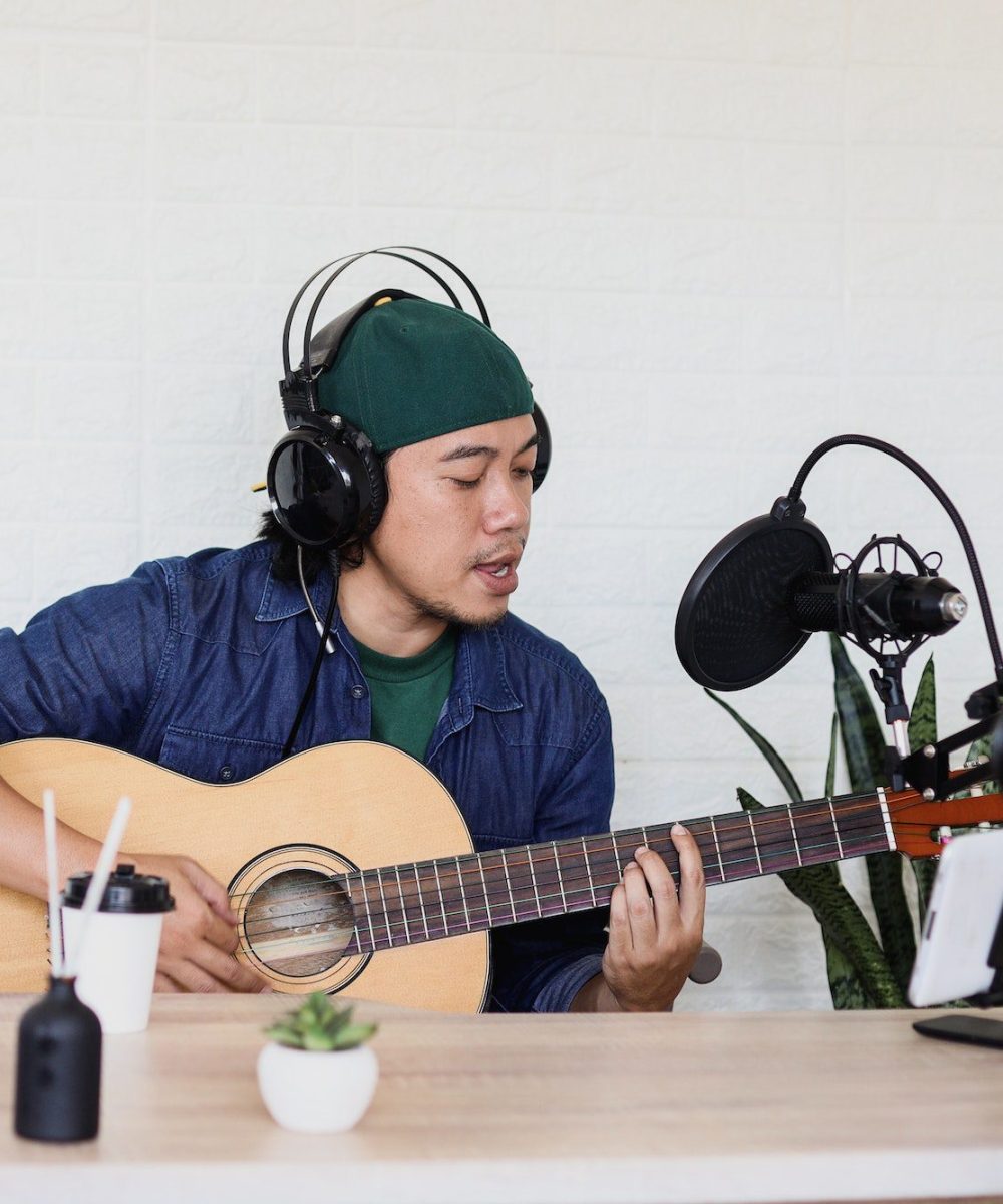 young-man-is-singing-and-play-guitar-on-music-podcast.jpg